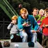 Familie spielt mit Crossboccia Family Pro Pack Race Arrows im Freien, umgeben von bunten Spielkugeln und fröhlicher Atmosphäre.